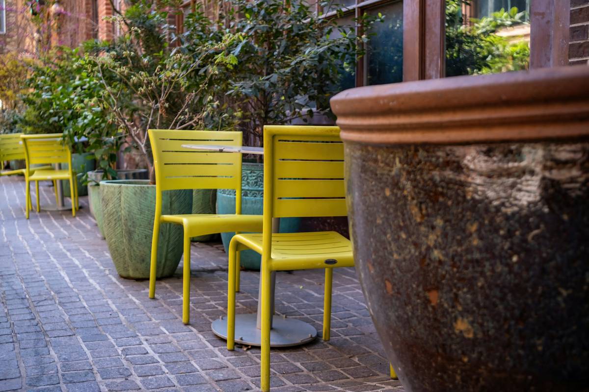 large garden decor featuring a tall ceramic planter filled with ornamental grasses beside a patio
