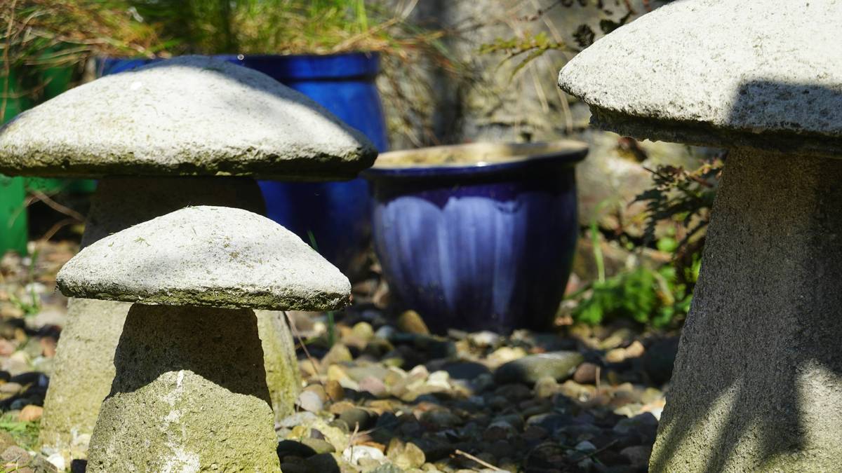 Stone mushroom garden ornaments with blue pots